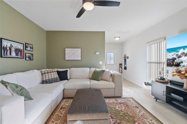 living room featuring ceiling fan and light wood-type flooring