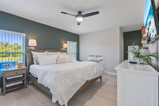 bedroom with ceiling fan and light hardwood / wood-style flooring