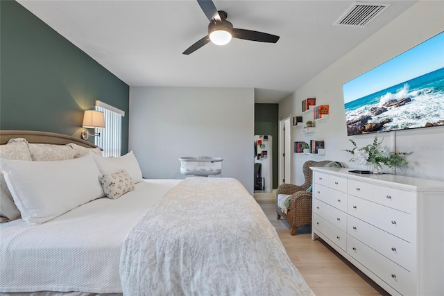 bedroom with light wood-type flooring and ceiling fan