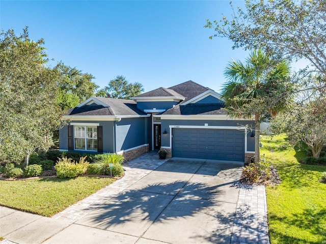 view of front of property featuring a front yard and a garage