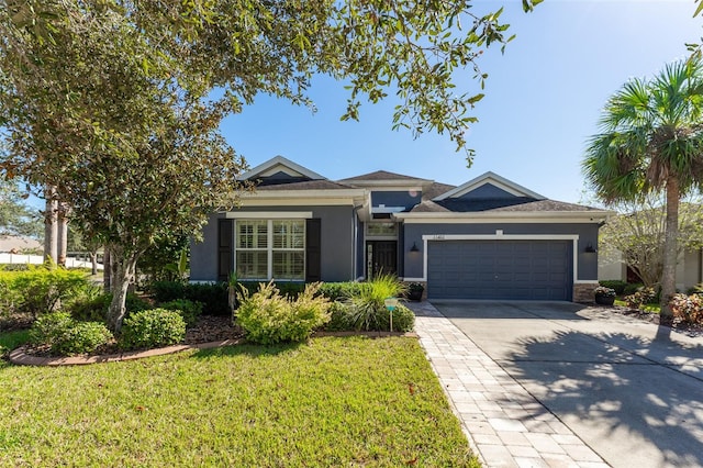 view of front of house featuring a garage and a front yard