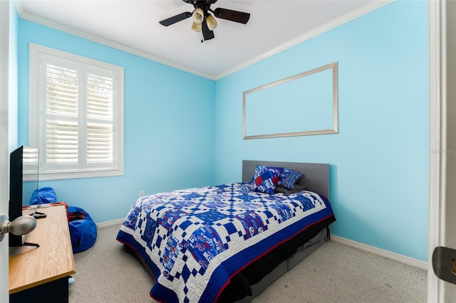 carpeted bedroom featuring ceiling fan and crown molding