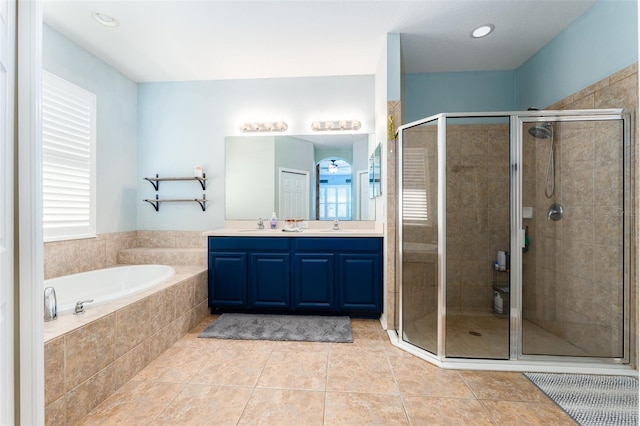 bathroom featuring tile patterned flooring, vanity, and separate shower and tub