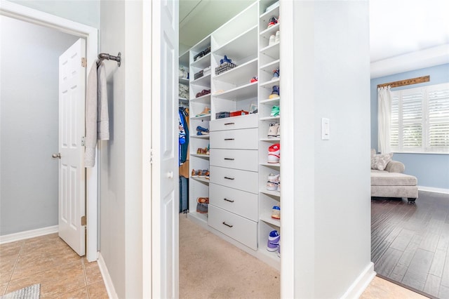 walk in closet featuring light hardwood / wood-style flooring