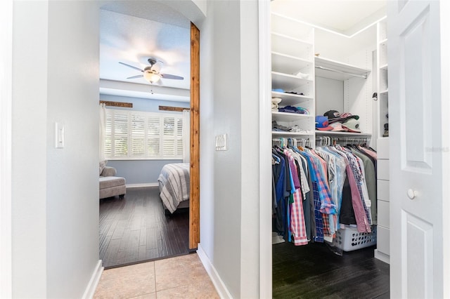 spacious closet with hardwood / wood-style flooring and ceiling fan