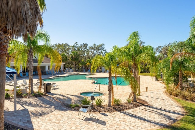 view of pool featuring a patio and a hot tub