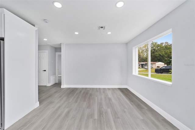 empty room with light hardwood / wood-style flooring