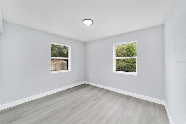 unfurnished room featuring light wood-type flooring and a wealth of natural light