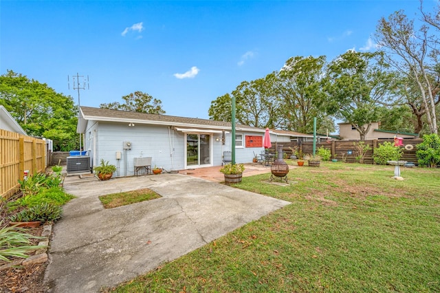 rear view of house featuring a patio area, a yard, and cooling unit