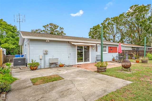 back of house with central AC unit, an outdoor fire pit, and a patio