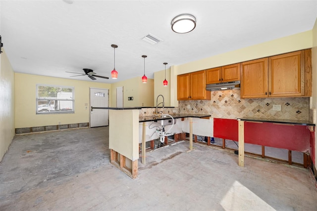 kitchen featuring a kitchen breakfast bar, hanging light fixtures, ceiling fan, decorative backsplash, and kitchen peninsula