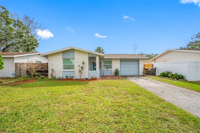 ranch-style house with a front yard and a garage