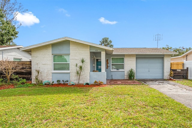 single story home with a garage and a front lawn