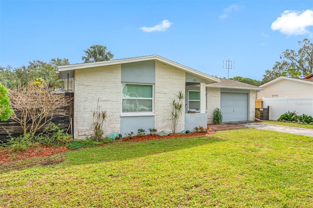 single story home featuring a garage and a front lawn