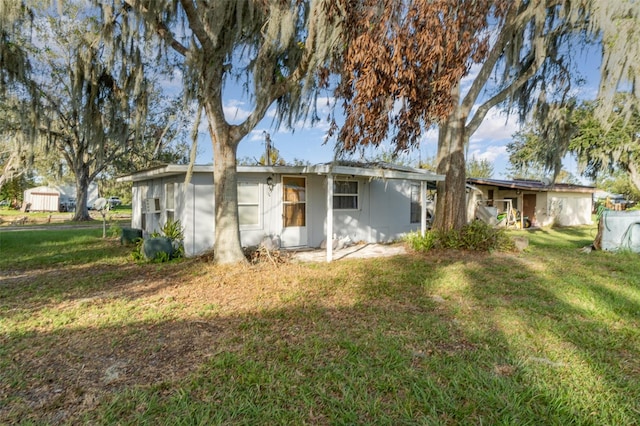 rear view of house with a yard