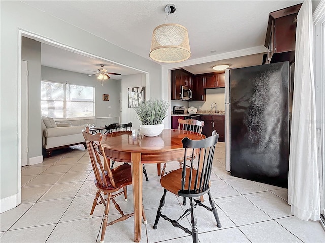 dining area with ceiling fan, sink, and light tile patterned floors