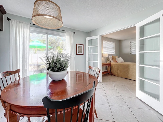 tiled dining area with a textured ceiling