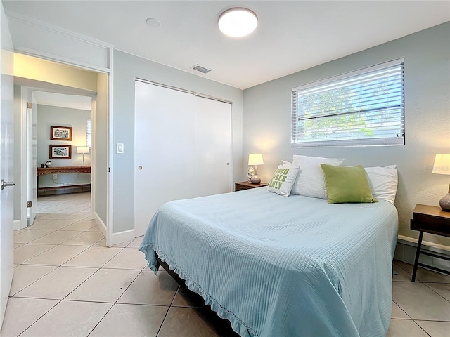 bedroom featuring a closet and light tile patterned flooring