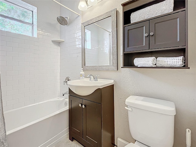 full bathroom featuring vanity, toilet, and tiled shower / bath