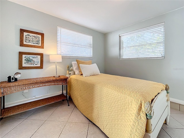 tiled bedroom with multiple windows