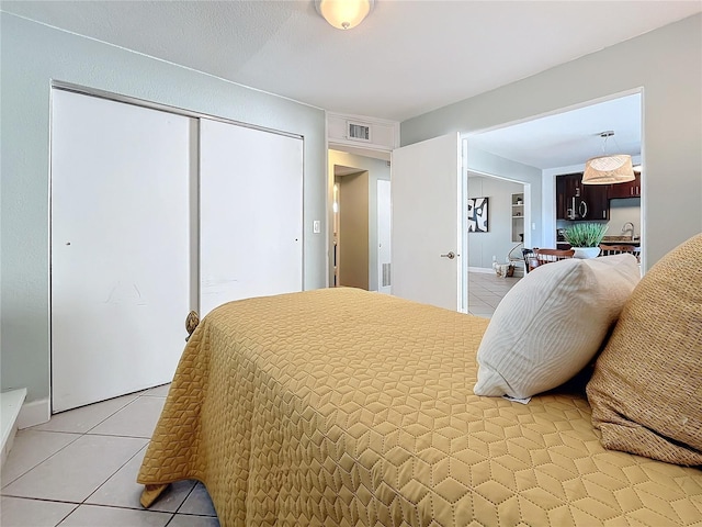 bedroom with tile patterned floors and sink