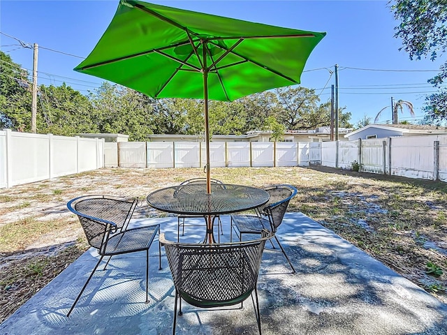 516 64th St S, Saint Petersburg, FL 33707 - fenced backyard with a patio and outdoor dining area