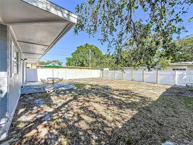 516 64th St S, Saint Petersburg, FL 33707 - fenced backyard featuring a patio area
