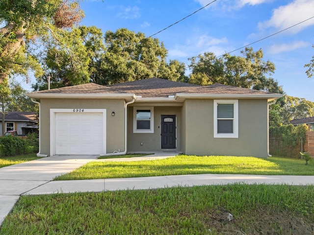 view of front facade with a garage and a front lawn