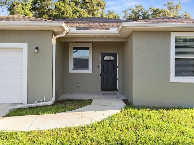 view of exterior entry featuring a garage