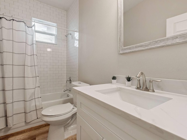 full bathroom featuring vanity, hardwood / wood-style flooring, toilet, and shower / bathtub combination with curtain