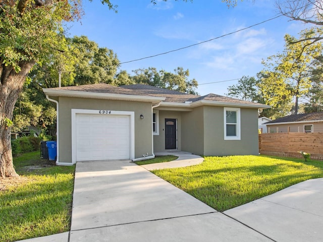 ranch-style home with a garage and a front yard