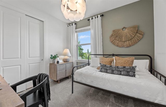 carpeted bedroom with an inviting chandelier and a closet