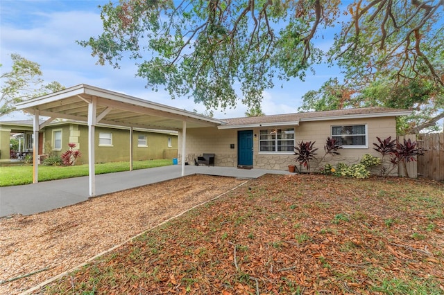 ranch-style house with a carport and a front yard