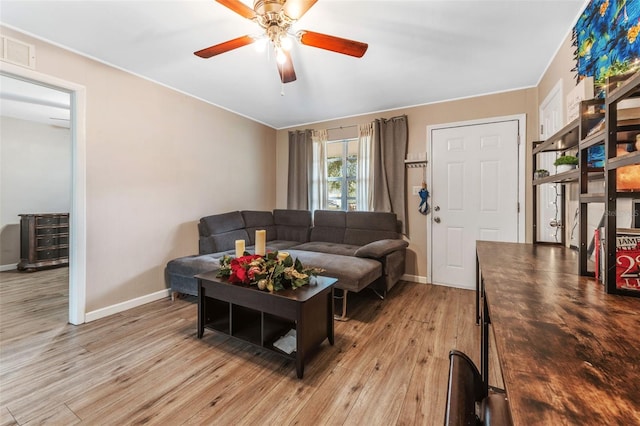 living room featuring light hardwood / wood-style flooring and ceiling fan