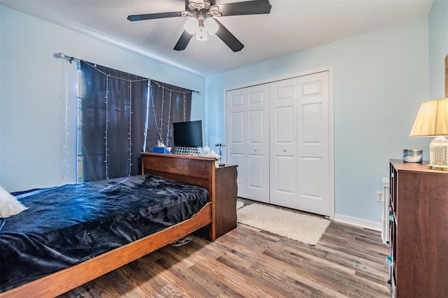 bedroom with ceiling fan, wood-type flooring, and a closet