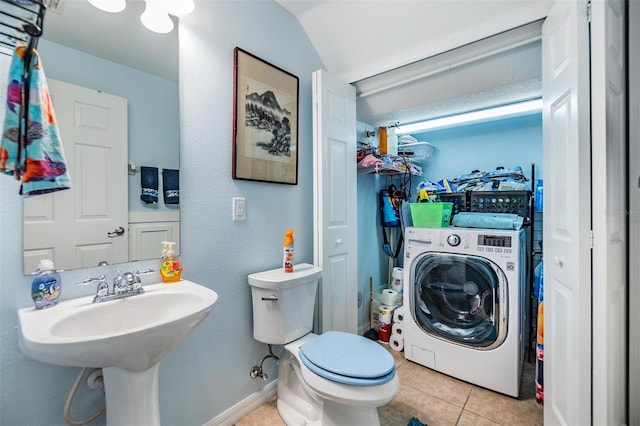 bathroom with toilet, tile patterned floors, washer / clothes dryer, and sink