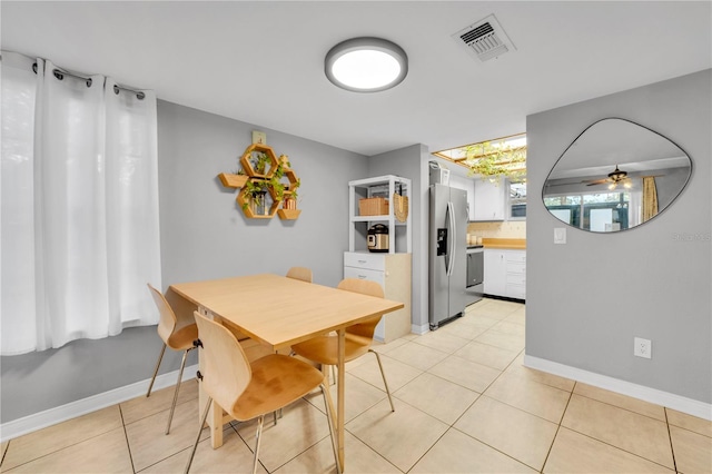 dining area with ceiling fan and light tile patterned floors