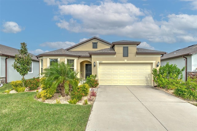 view of front of house with a front yard and a garage