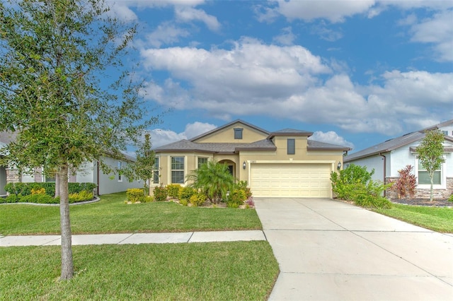 view of front of house featuring a garage and a front lawn