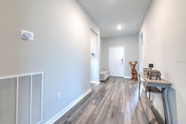 hallway with hardwood / wood-style floors