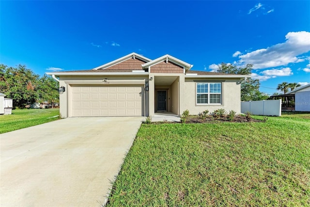 view of front of property with a front yard and a garage