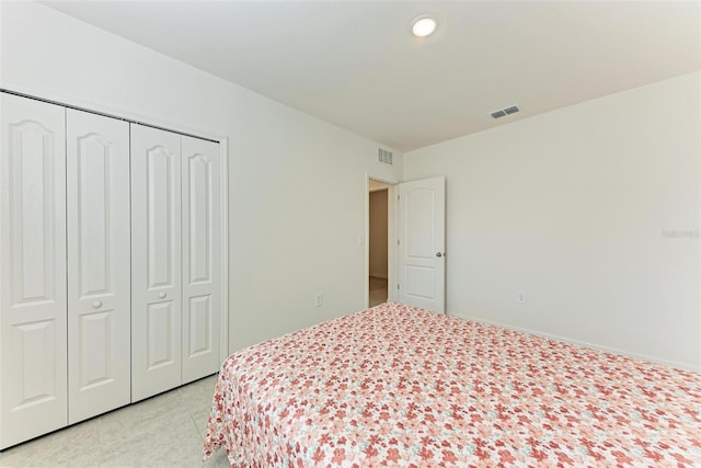 bedroom with light carpet and a closet