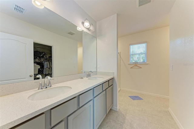 bathroom with tile patterned floors and vanity