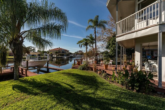 view of yard featuring a boat dock and a water view