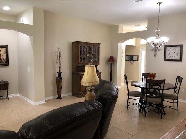 tiled dining space with a notable chandelier