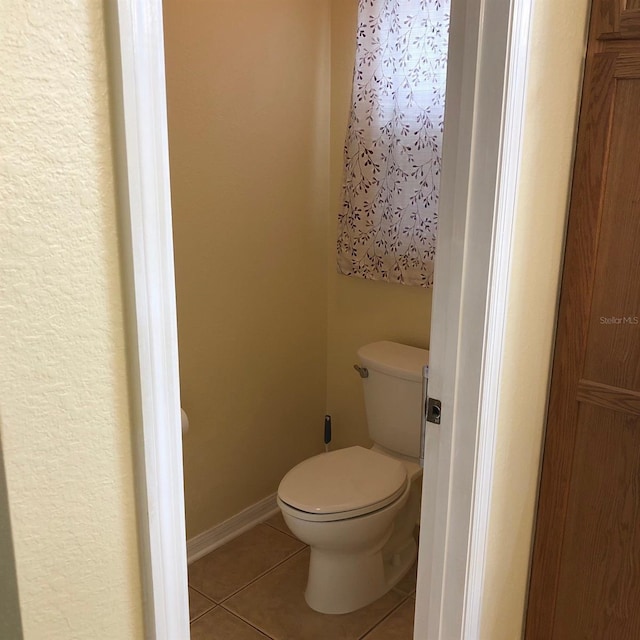 bathroom with tile patterned flooring and toilet