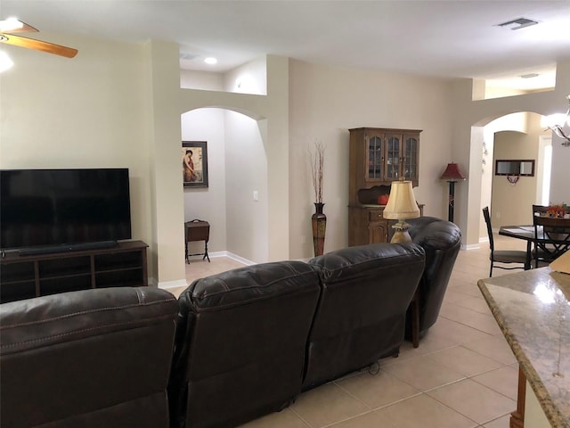 living room with ceiling fan and light tile patterned floors