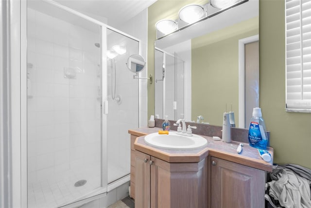 bathroom featuring vanity and a shower with shower door