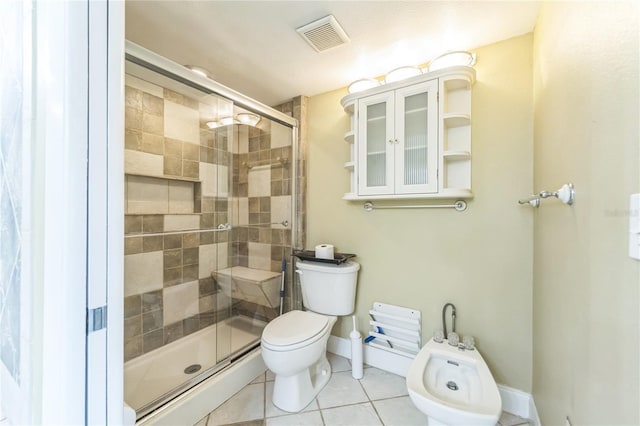 bathroom with visible vents, toilet, tile patterned floors, a shower stall, and a bidet