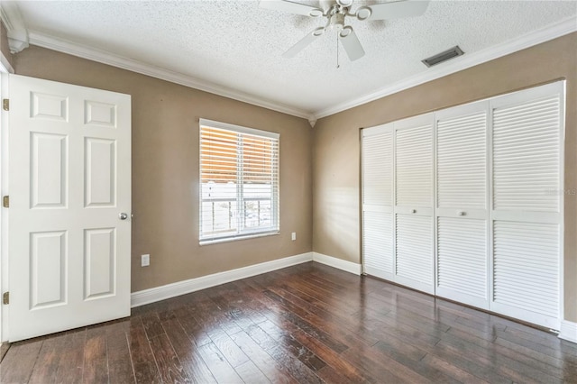 unfurnished bedroom featuring ornamental molding, visible vents, and dark wood finished floors